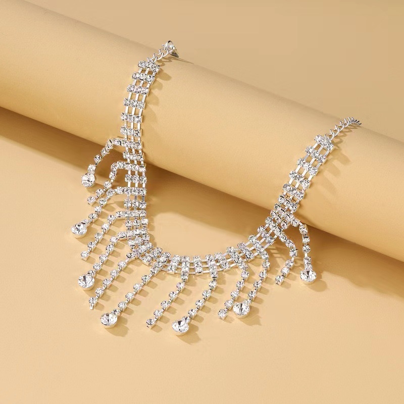 Brățară exotică pentru gleznă din argint, cu pandantiv în formă de picătură și încrustări de pietre în aur alb