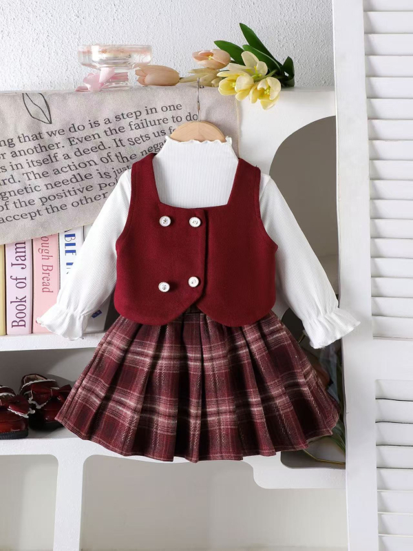 Costum fetițe din trei piese: vestă cu nasturi dubli, top cu mânecă lungă și fustă în carouri; 95% bumbac