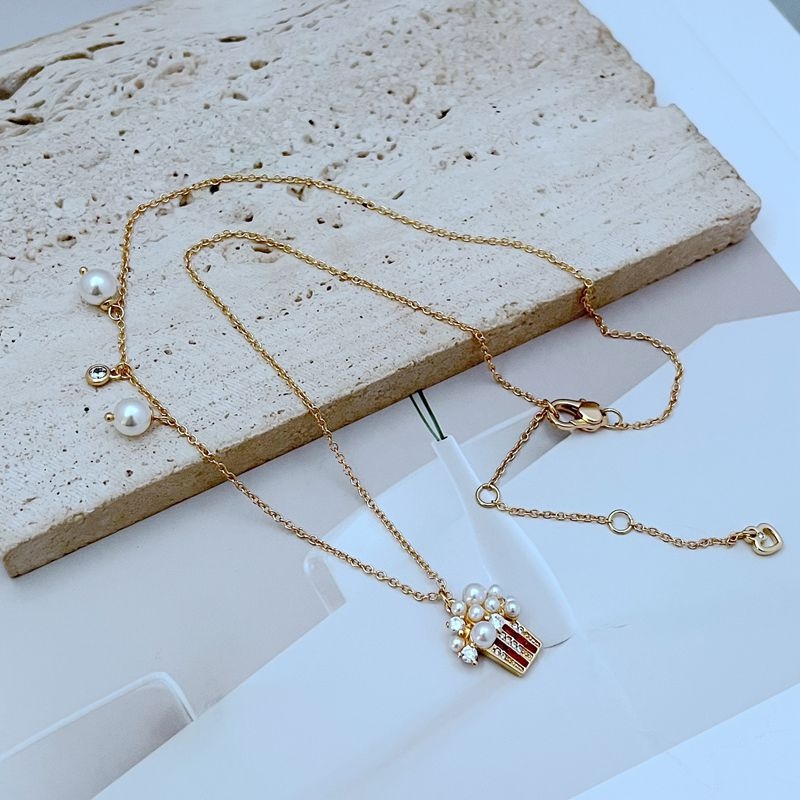 Set nakita: metalne naušnice i ogrlica, lanac u obliku križa, medaljon s kristalima i perlama, ženski stil, ljeto 2024