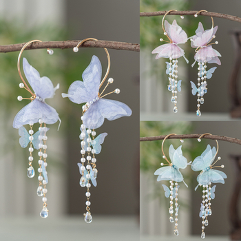 Gyermekeknek készült kínai stílusú pillangóval és bojtokkal díszített fülbevaló, kézzel készült, eredeti dizájn; anyagok: üveg / lazurit; szezon: 2025 tél