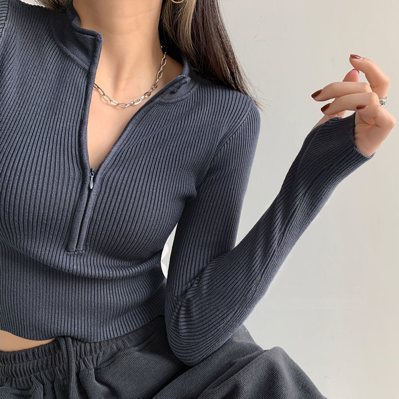 Pulover tricotat pentru femei, cu fermoar și guler înalt (stand), croială slim, mâneci lungi, lungime scurtă 40–50 cm; material poliester/viscoză; stil minimalist japonez-coreean.