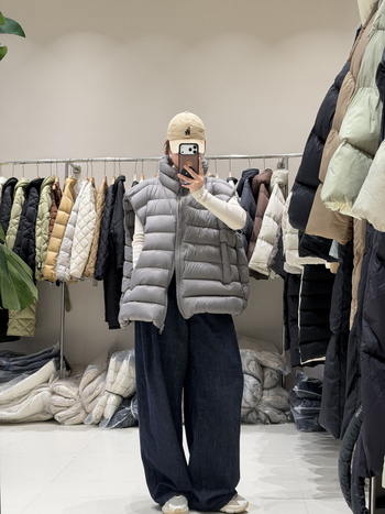Ženski down vest, slobodan kroj, najlon materijal, zip, polukratak vrat, duljina 50–65 cm, sadržaj per 86–90%, 101–200 g punjenja