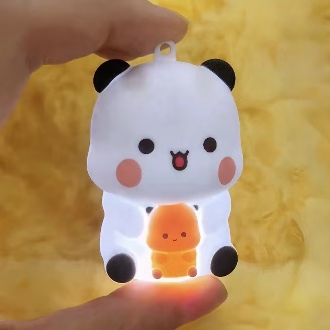 Gaismains atslēgu piekariņš mugursomai, mīļa plastmasas runājoša lelle ar «es tevi mīlu» balsu ierakstiem (14+ rotaļlieta).