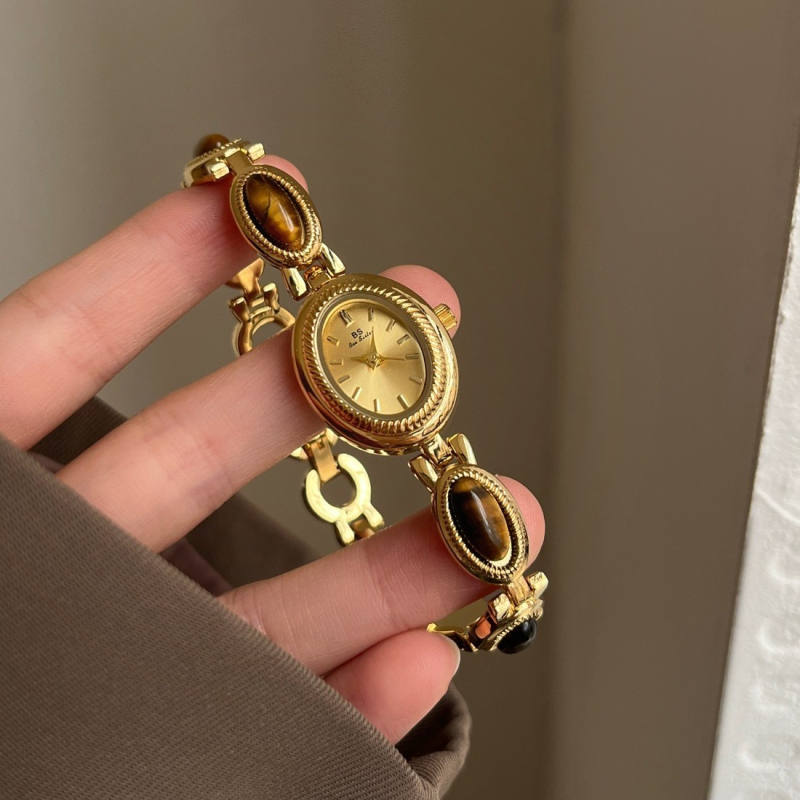 Ženski kvarcni sat s ovalnim brojčanikom, metalna narukvica, kućište od legure, spiralna krunica, srednjovjekovni stil