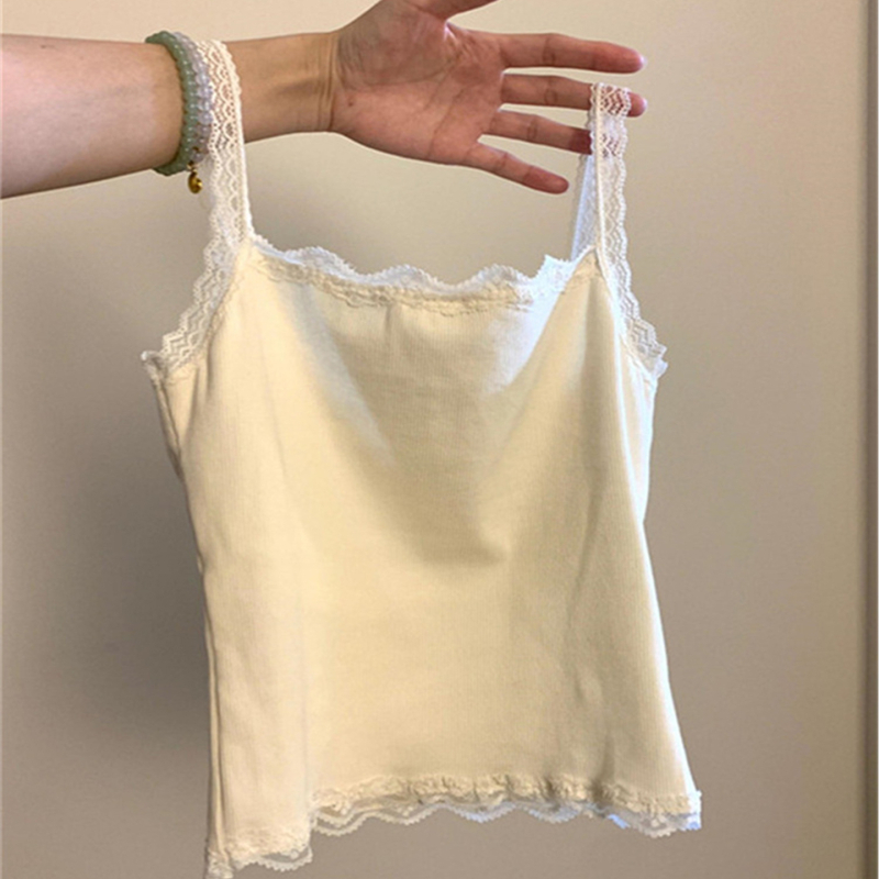 Nėrinių kamizolė su įmontuotomis krūtinės pagalvėlėmis, siaura kirpimo linija, itin trumpas ilgis, medvilnės–viskozės–elastano mišinys, peties dirželiai neatsiejami