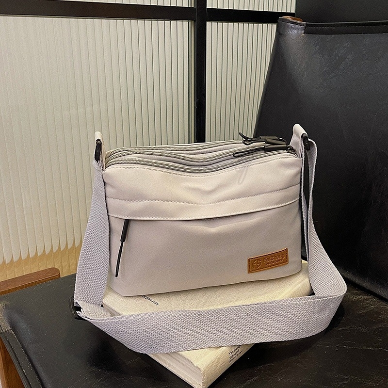 Crossbody torba, mali kvadratni dizajn, poliester materijal, poliester podstava, zatvaranje na zip, laminirani unutarnji džep, pogodno za slobodno vrijeme