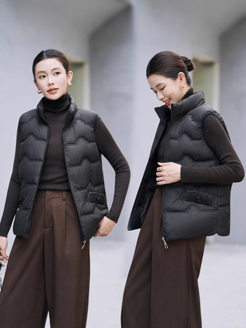 Sieviešu veste ar stāvošu apkakli; tievs piegriezums; īss garums 40–50 cm; rāvējslēdzējs; poliestera audums