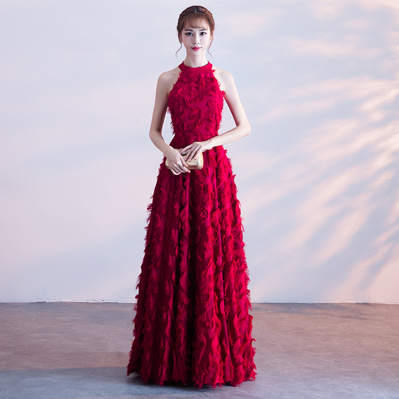 Balta plunksnų apdaila su atvirais pečiais, ilga vakarinė suknelė su aukštu liemeniu, skirta baigimui ir choro pasirodymams