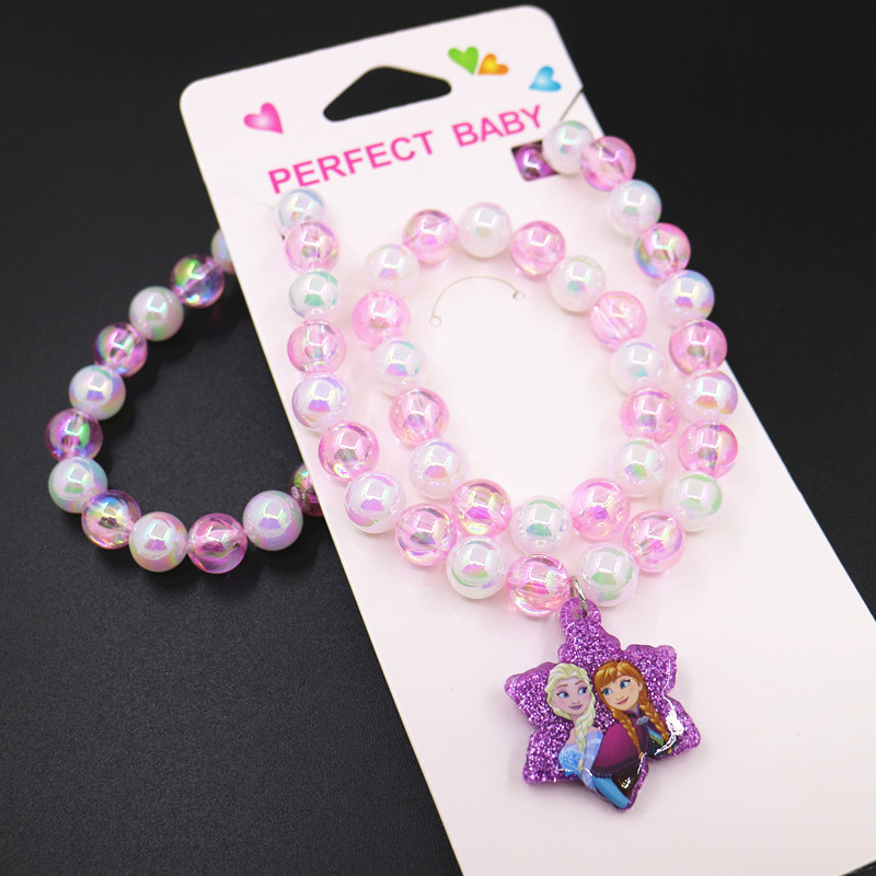 Bērnu kaklarotas un rokassprādzes komplekts ar pasakas princese motīvu — rezīns, atsevišķi iepakots, tīrība K5, 0,05 dārgmetāla kvalitāte, 2021. gada pavasaris