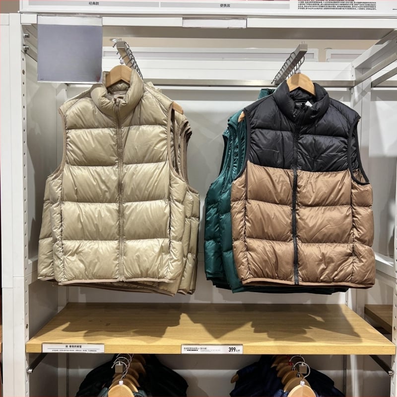 Unisex ziemas viegla pūka veste ar corduroy virsējā auduma, balta pīļu pūka 55–60% pilda, <100 g pildījums, kapuce, stāvošā apkakle, galvenais materiāls polipropilēns