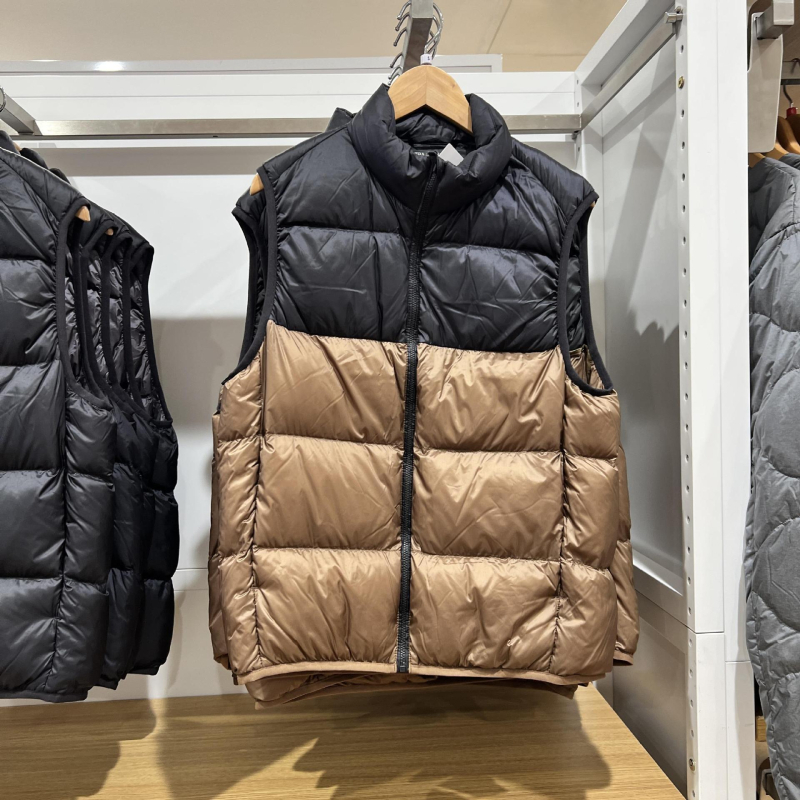 Unisex ziemas viegla pūka veste ar corduroy virsējā auduma, balta pīļu pūka 55–60% pilda, <100 g pildījums, kapuce, stāvošā apkakle, galvenais materiāls polipropilēns