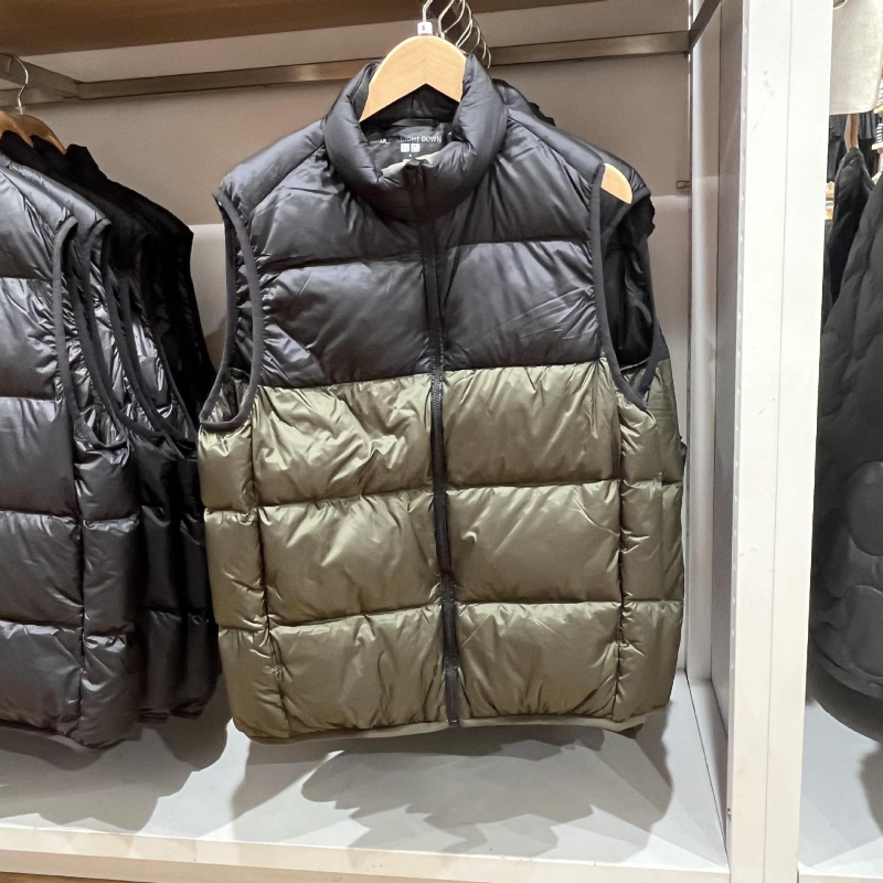 Unisex ziemas viegla pūka veste ar corduroy virsējā auduma, balta pīļu pūka 55–60% pilda, <100 g pildījums, kapuce, stāvošā apkakle, galvenais materiāls polipropilēns