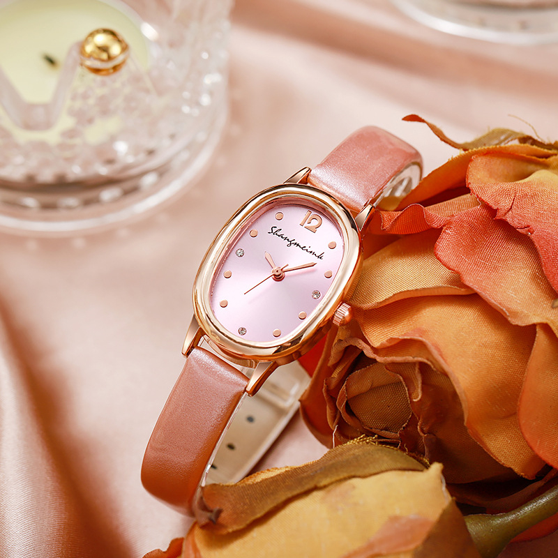 Női diákóra ovális számlappal, kvarc működésű, analóg kijelző, műbőr szíj, ötvözetes tokkal