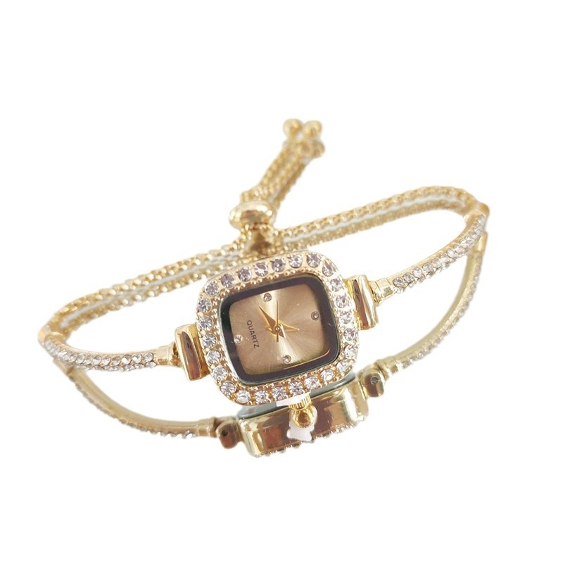 Ženski kvarcni sat s dekorativnim kamenčićima i svjetskim vremenom; metalno kućište i kaiš, okrugli brojčanik, leptir kopča