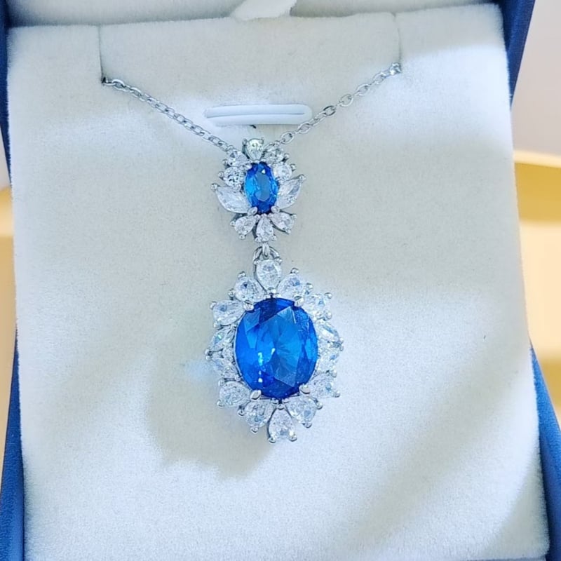 Virágos három darabos ékszerszett: gyűrű, nyaklánc, fülbevaló; alap bevonattal; betoldott szintetikus kövekkel; O alakú lánc; virág motívum