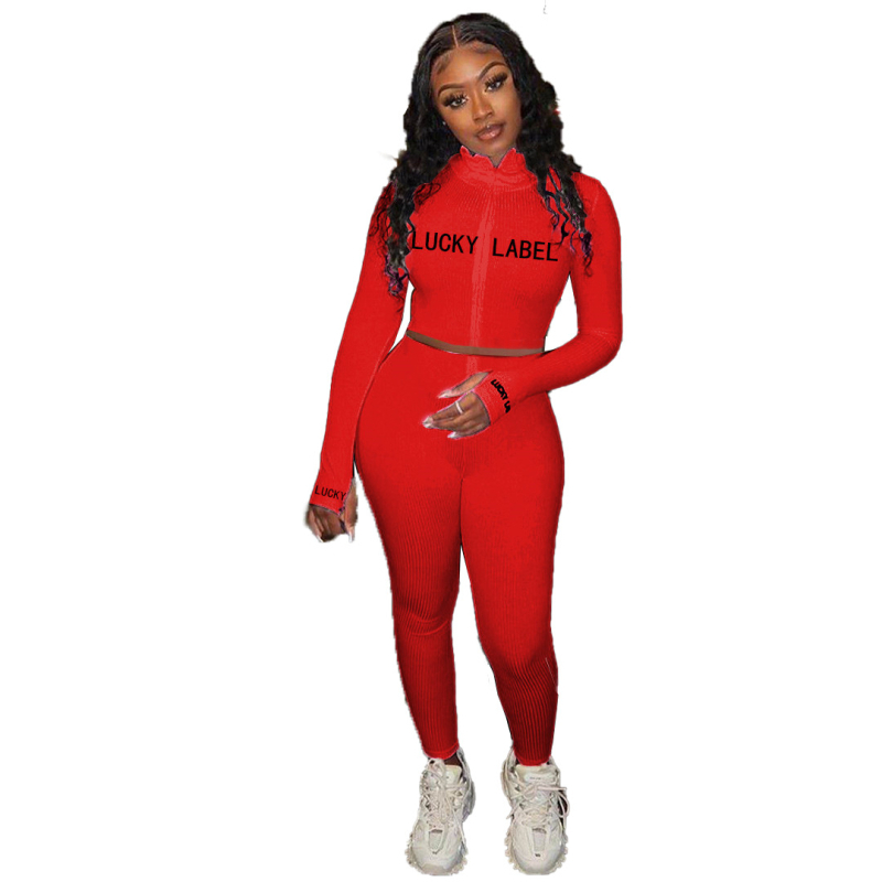 Ženski dvodijelni komplet: gornji dio s visokim ovratnikom, šav s literama i zatvaračem, dugi rukavi; uske hlače; poliester 71-80%