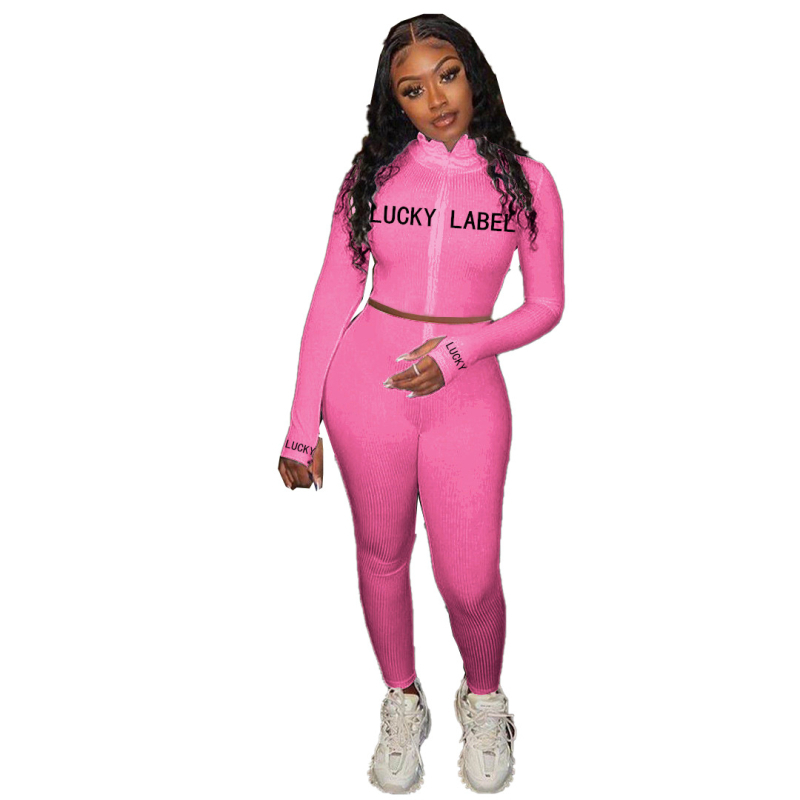 Ženski dvodijelni komplet: gornji dio s visokim ovratnikom, šav s literama i zatvaračem, dugi rukavi; uske hlače; poliester 71-80%