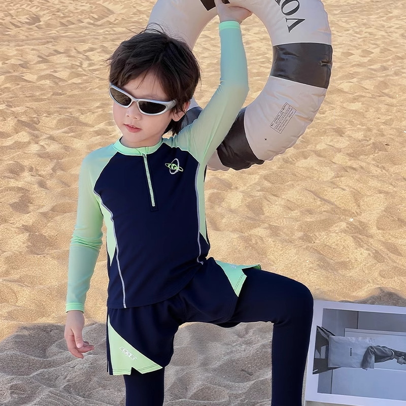 Berniukų dviejų dalių plaukimo komplektas su ilgomis rankovėmis ir ilgomis kelnių, saulės apsauga — poliesterio audinys 85%, poliesterio pamušalas 85%, svoris 150–300 g/m², plaukimui