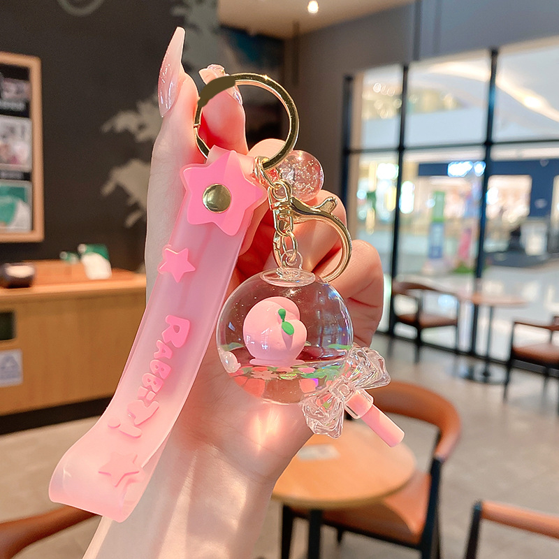 Képregényes kulcstartó, akril üvegben mozgó homokkal, gyerekek iskolatáskához