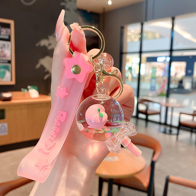 Képregényes kulcstartó, akril üvegben mozgó homokkal, gyerekek iskolatáskához