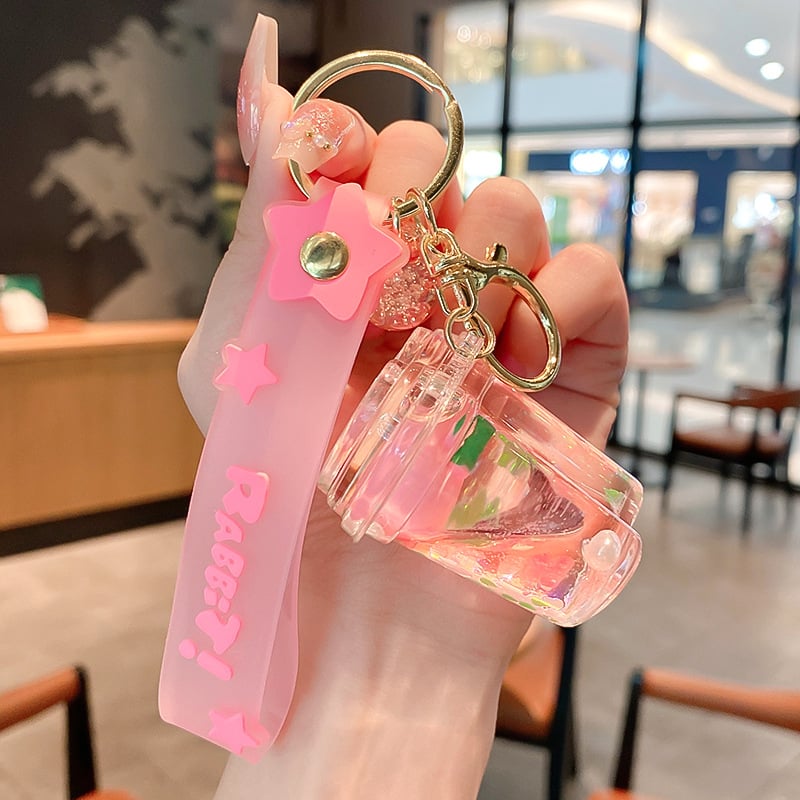 Képregényes kulcstartó, akril üvegben mozgó homokkal, gyerekek iskolatáskához