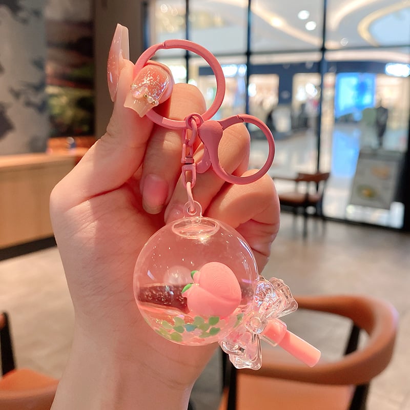 Képregényes kulcstartó, akril üvegben mozgó homokkal, gyerekek iskolatáskához