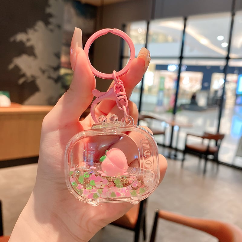 Képregényes kulcstartó, akril üvegben mozgó homokkal, gyerekek iskolatáskához