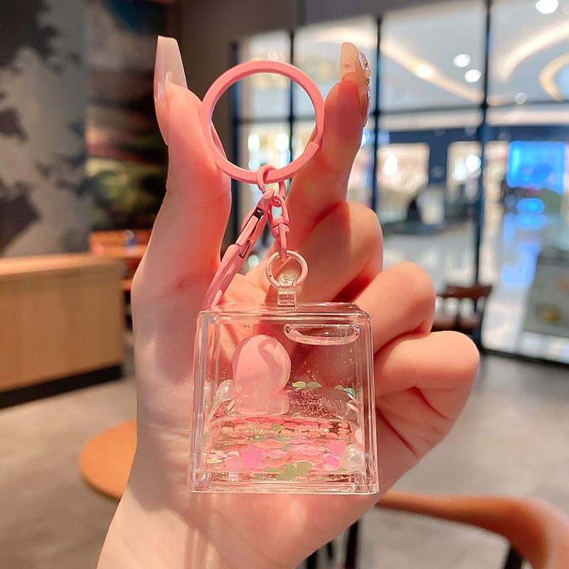 Képregényes kulcstartó, akril üvegben mozgó homokkal, gyerekek iskolatáskához