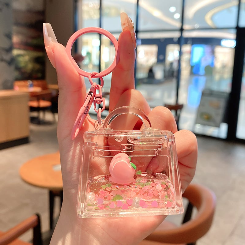 Képregényes kulcstartó, akril üvegben mozgó homokkal, gyerekek iskolatáskához