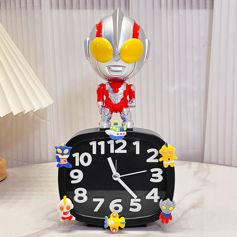 Bērniem paredzēts galda pulkstenis – karikatūru stilā, ar baterijām, izturīgs pret kritieniem (plastmasas korpuss, plastmasas cifernis)