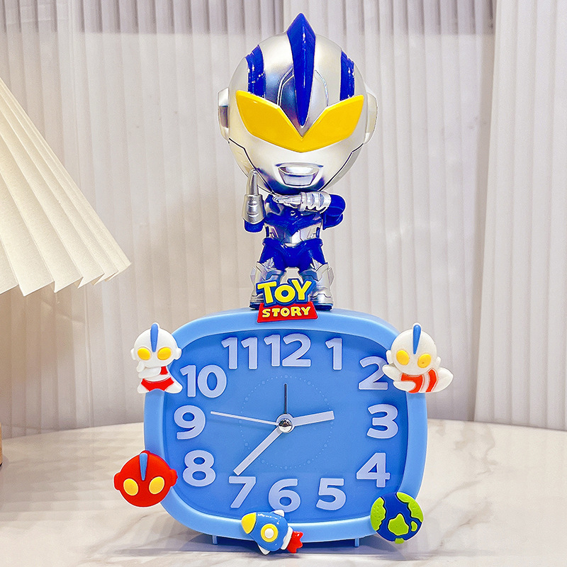 Bērniem paredzēts galda pulkstenis – karikatūru stilā, ar baterijām, izturīgs pret kritieniem (plastmasas korpuss, plastmasas cifernis)