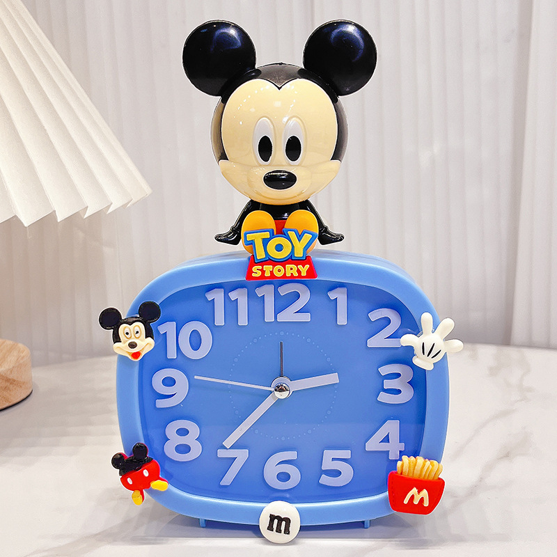 Bērniem paredzēts galda pulkstenis – karikatūru stilā, ar baterijām, izturīgs pret kritieniem (plastmasas korpuss, plastmasas cifernis)