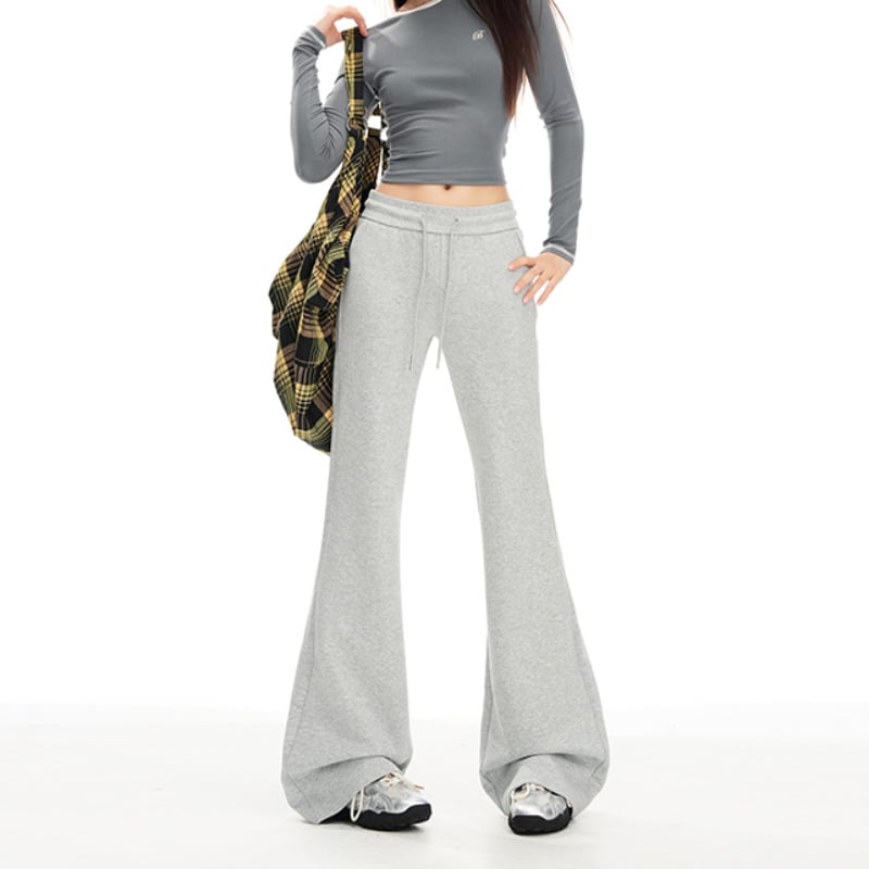 Moteriškos sportinės kelnės su švelniai išsiplėšiančiu kelniu, žieminis fliso pamušalas, žemas juosmuo, ilgos iki grindų, poliesterio–medvilnės mišinys