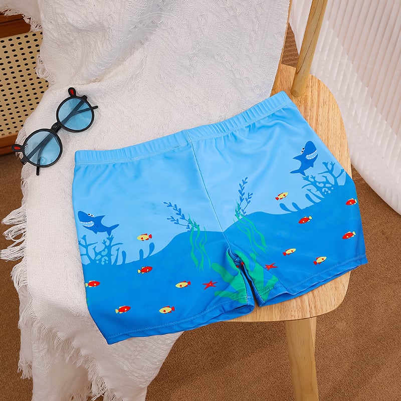 Vaikų plaukimo šortai su karikatūrų spauda, kvėpuojantys, greitai džiūstantys; audinys poliesteris 88%, vidinis pamušalas 12%