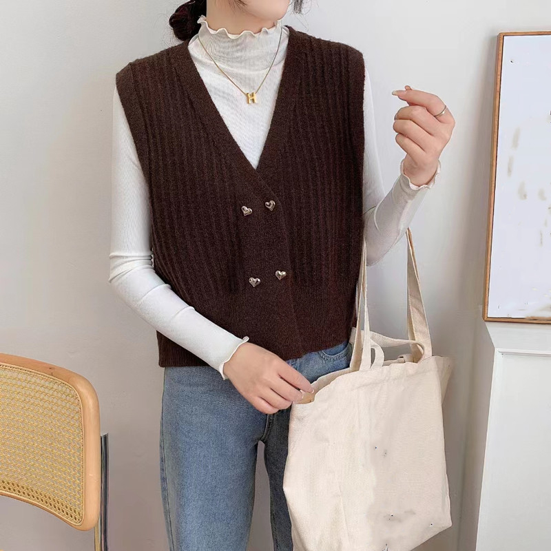 Moteriška megzta be rankovių liemenė su V formos kaklu, dvigubo užsegimo plokštelė, 3D raštas, akrilo-poliesterio mišinys