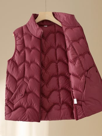 Moteriška žieminė liemenė su pūkų-pam izoliacija, pagrindinis audinys poliester (>95%), ilgis 50–65 cm, be apykaklės, lyginimo nereikalauja, kasdienis elegantiškas stilius