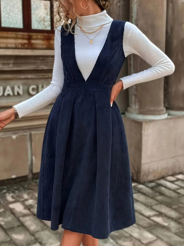 Poliészter anyagú közép hosszúságú ruha, magas derékkal és V-nyakú kivágással