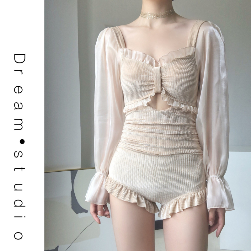 Ženski jednodijelni kupaći kostim s dugim rukavima, jednobojni, bez leđa; umetci za dojke (bez čelične potpore); podstava: Spandex.
