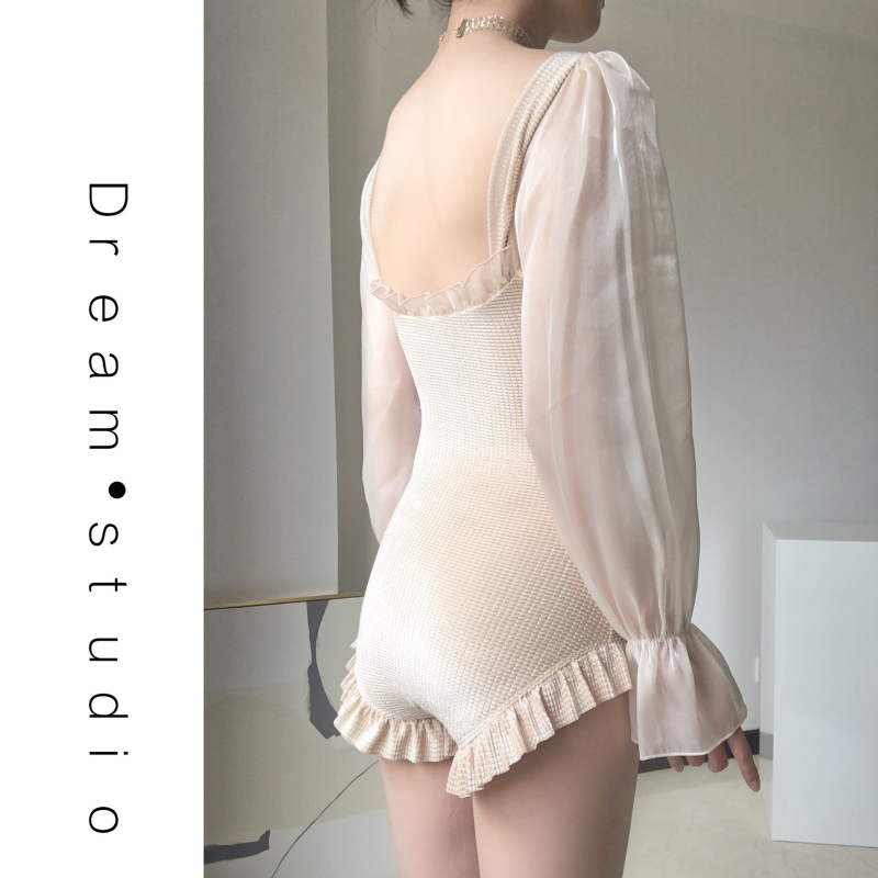 Ženski jednodijelni kupaći kostim s dugim rukavima, jednobojni, bez leđa; umetci za dojke (bez čelične potpore); podstava: Spandex.