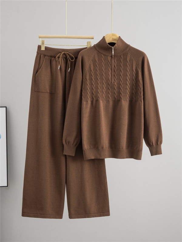 Дамски плетен костюм от две части: пуловер с половин цип и панталони с широки крачоли; монотонен десен; вискоза 50–70% и полиестер 30–50%; мотив twist-flower; дълги ръкави; есен 2025