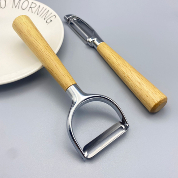 Multifunkcionális cinkötvözetből készült hántoló tölgyfa fogantyúval — hántolás, kaparó, gyümölcs- és zöldségpucoló, dinnyepucoló; logó nyomtatás; testreszabás elérhető