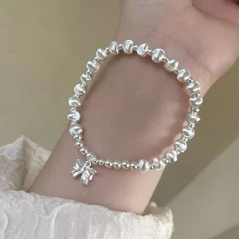 Virágmotívumos, kerek gyöngyökkel és masni fityegővel készült karkötő, réz, elektroplakálás, koreai stílusú nőknek, kézműves ékszer, 2024 tavasz