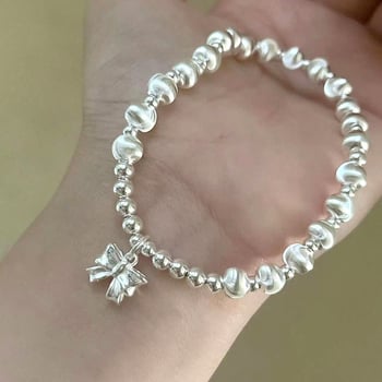 Virágmotívumos, kerek gyöngyökkel és masni fityegővel készült karkötő, réz, elektroplakálás, koreai stílusú nőknek, kézműves ékszer, 2024 tavasz