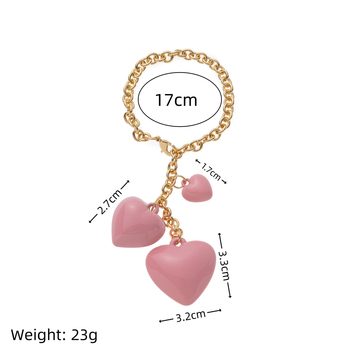 Réz kulcstartó és táskadísz, szív alakú, gyanta gyöngy akcentussal; minták Szív/Vízcső/Zengő; stílus Személyes Trend; 2025 nyár