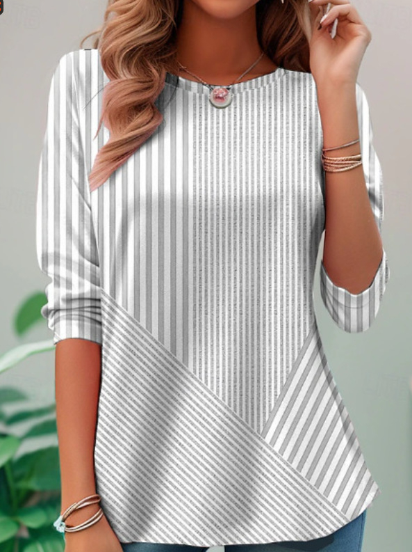 Poliészter blúz V-nyakkal és nyitott plackettel elöl, aszimmetrikus csíkos patchwork 3D hatással, rövid ujjú.