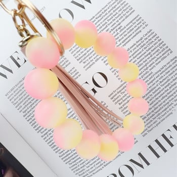 Fénylő szilikon gyöngy kulcstartó bojtos karkötővel