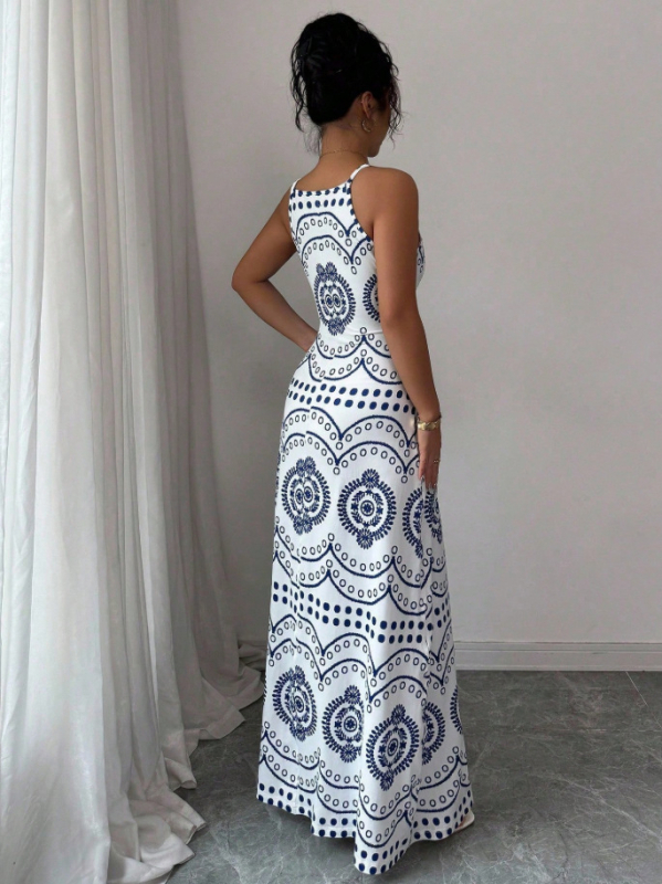 Elegantna duga haljina na tanke remenčiće s floralnim printom od Milk Silk materijala, silueta kišobran suknja, struk: srednji (Materijal: Milk Silk; Uzorak: Cvjetni; Duljina: Duga; Tip haljine: Kišobran suknja; Struk: Srednji)