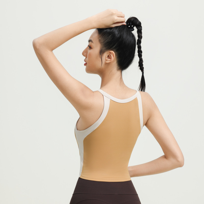 Αθλητικό γιλέκο με ενσωματωμένα κύπελλα, σχέδιο με χρωματικό μπλοκ, σταυρωτό πίσω, υποστήριξη απορρόφησης κραδασμών και απομάκρυνση ιδρώτα, ύφασμα νάιλον/elastan (75/25), κατάλληλο για το τρέξιμο και την προπόνηση.