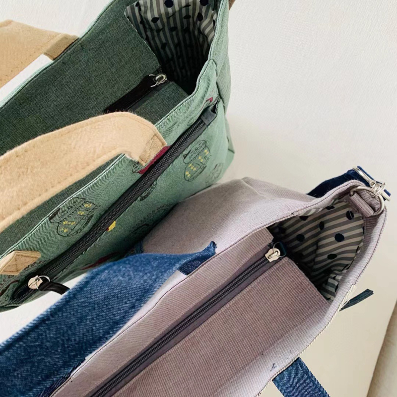 Ukrašena crossbody torba za gradske potrebe — platno, zatvarač, poliester podstava.