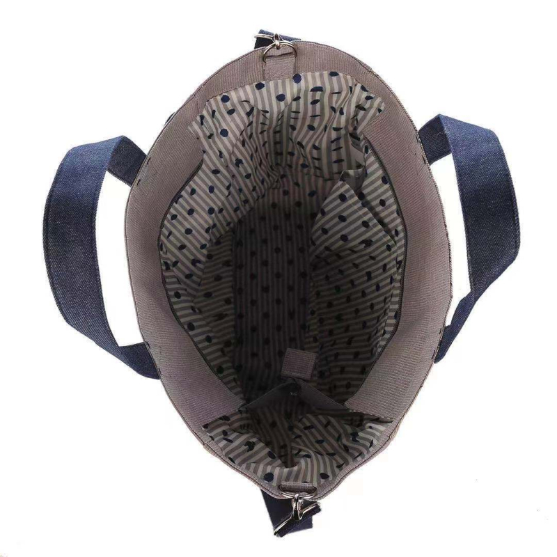 Ukrašena crossbody torba za gradske potrebe — platno, zatvarač, poliester podstava.